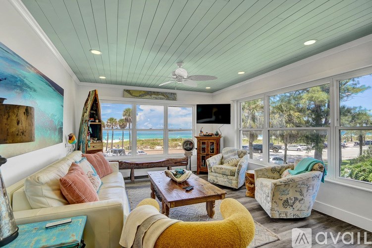 A living room with a view of the beach.