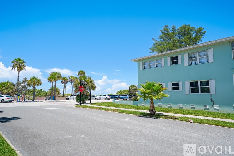A street view with a red stop sign and a blue building.