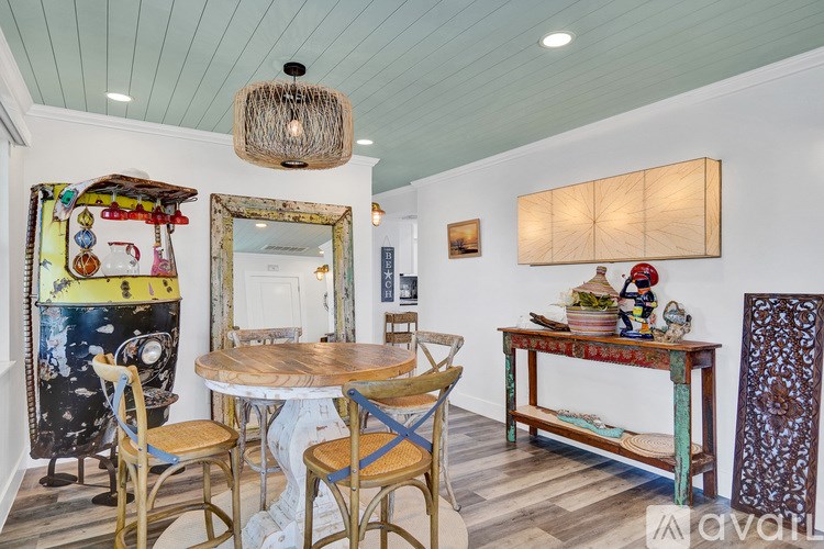 A dining room with a wooden table and chairs.