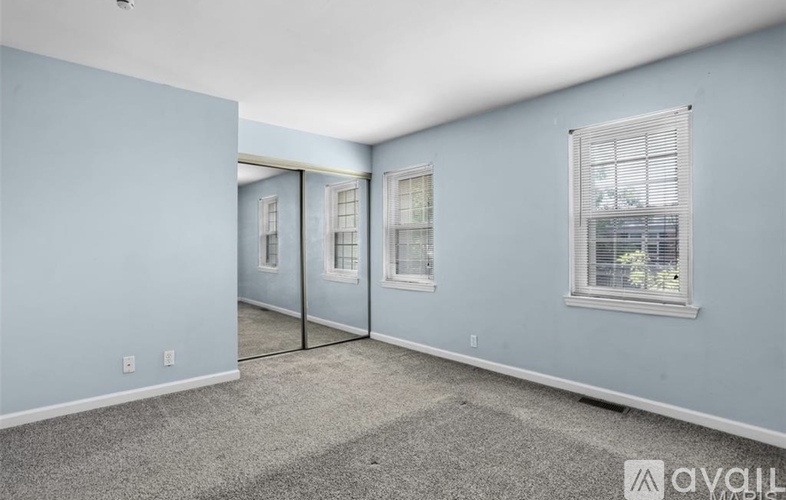 A room with light blue walls and a carpeted floor.