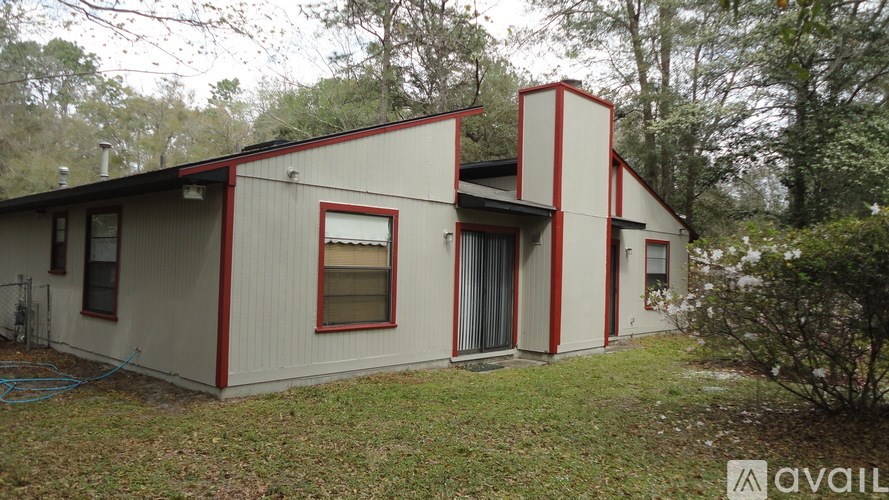 A house with a red and white exterior is for sale.