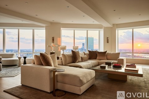 A modern living room with a large sectional sofa and a coffee table.