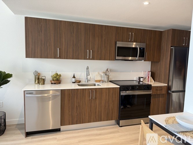 A kitchen with wooden cabinets and stainless steel appliances.