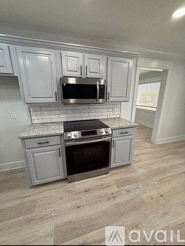 A kitchen with a stove top oven and microwave above it.