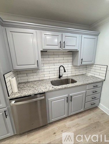 A kitchen with a sink and cabinets.