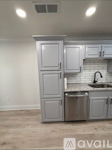 A kitchen with a sink and cabinets.