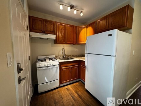 A kitchen with white cabinets and appliances.