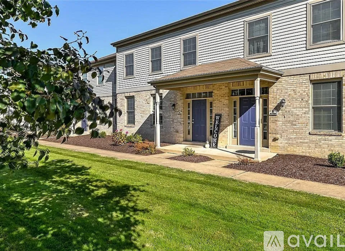 A house with a blue door and a sign that says "available" in front of it.