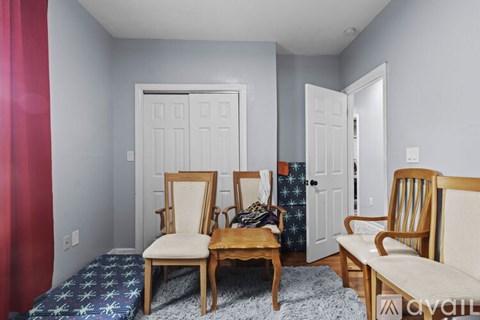 A living room with two chairs and a sofa.