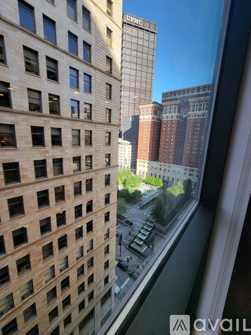 A patio with a table and chairs is surrounded by buildings.