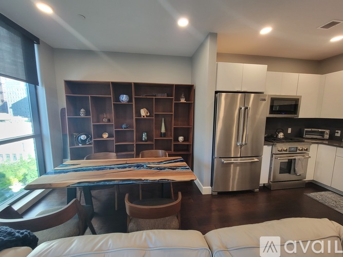 A modern kitchen with stainless steel appliances and white cabinets.