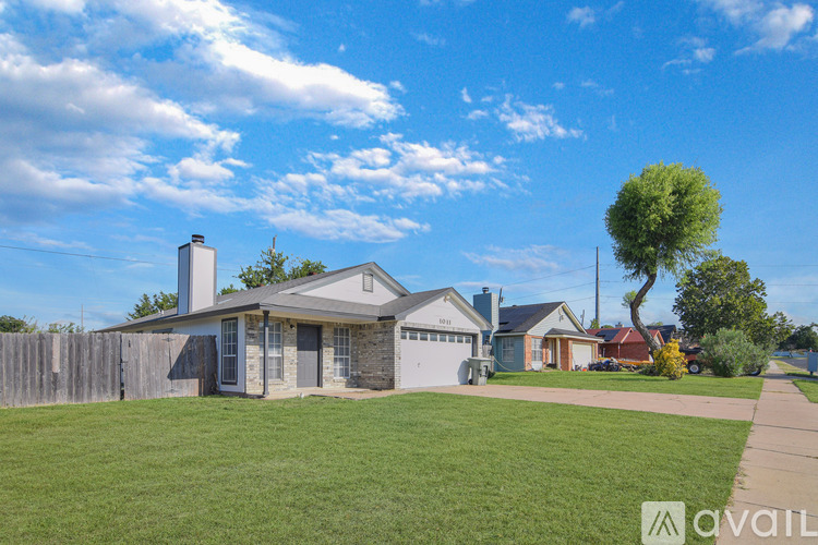 A house with a large front yard is for sale.