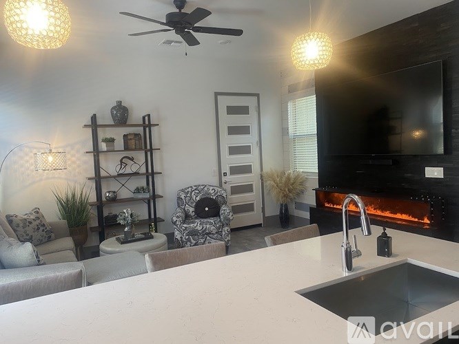 A modern kitchen with a large island and a fireplace.