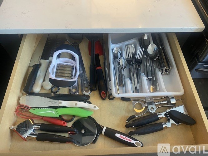 A drawer full of various utensils and kitchen tools.