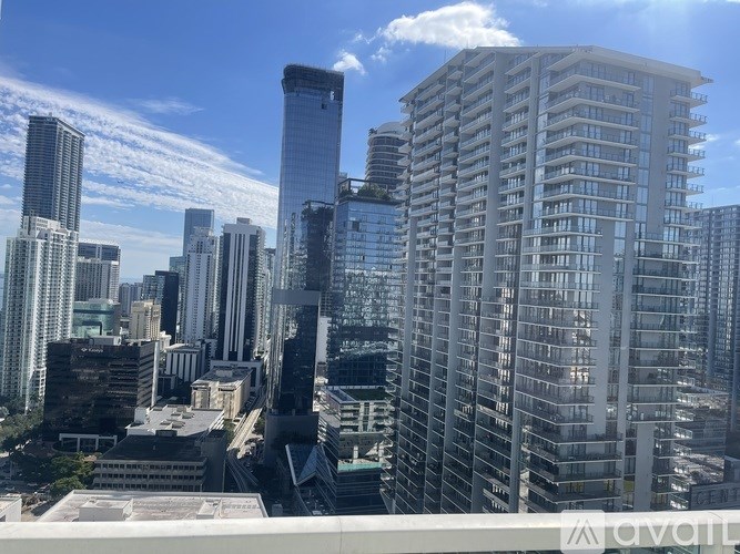 A cityscape with tall buildings and a clear sky.