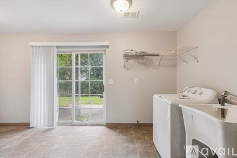 A bathroom with a white sink and a sliding glass door.