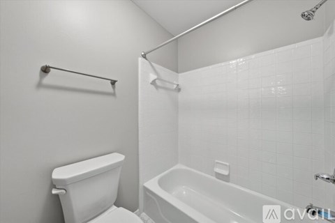 A room with a window and a ceiling fan.