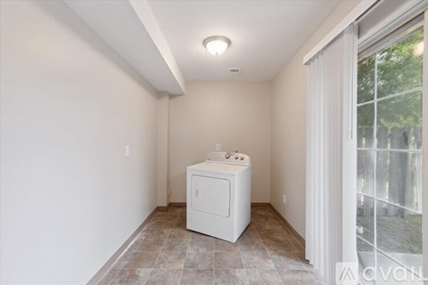 A house with a brown fence and a glass door.