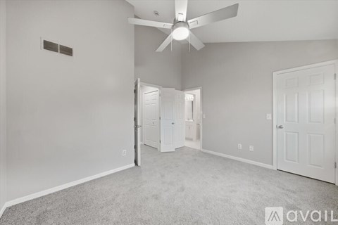 A bathroom with a white vanity and a white door.