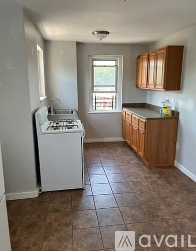 A kitchen with a dishwasher and a window.