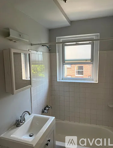 A bathroom with a window and a sink.