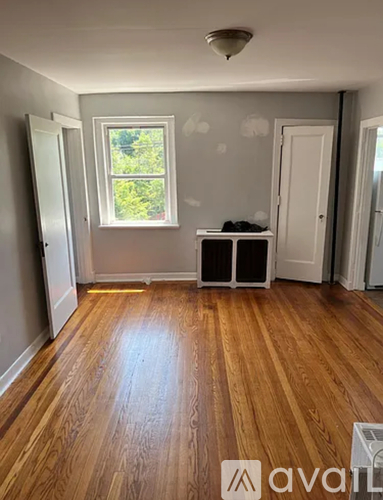 A room with wooden floors and a window.