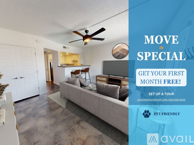 A living room with a couch, a fan, and a mirror on the wall.