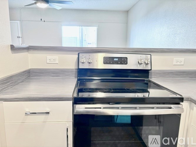 A modern kitchen with a built-in oven and stove top.