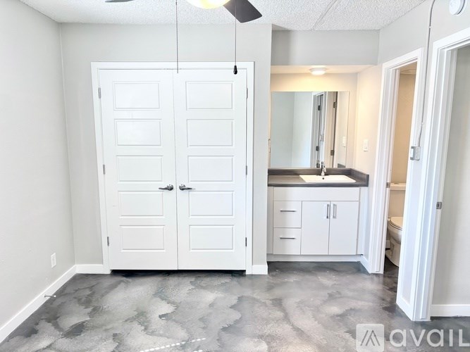 A bathroom with a white cabinet and a sink.