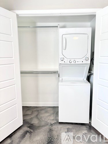 A white washing machine and dryer in a small laundry room.