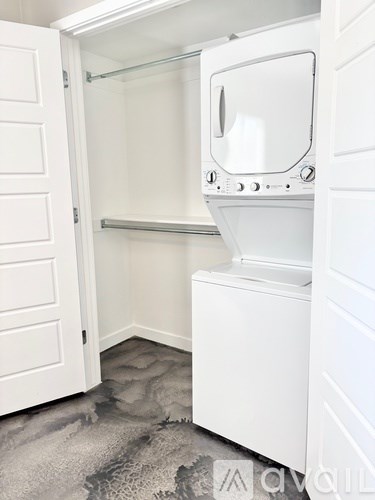 A white washing machine and dryer in a small laundry room.