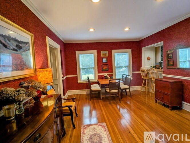 A dining room with a wooden table and chairs.