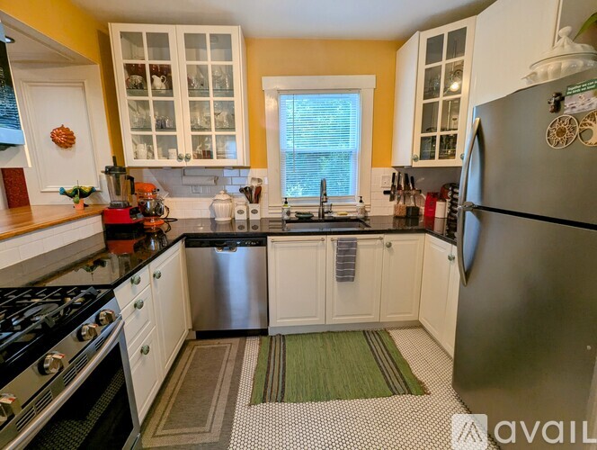 A kitchen with a stove, refrigerator, and cabinets.