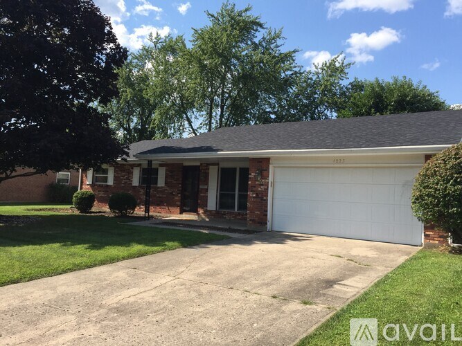 A house with a white garage door is for sale.