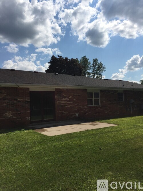 A building with a grassy area in front of it.