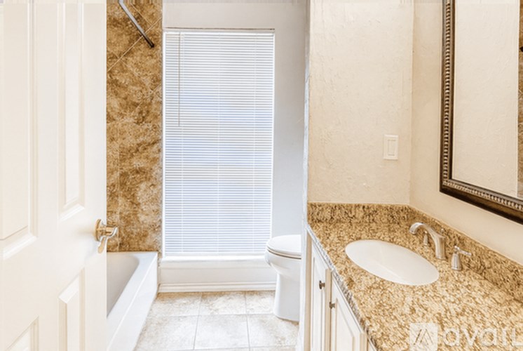 A bathroom with a toilet, sink, and tub.