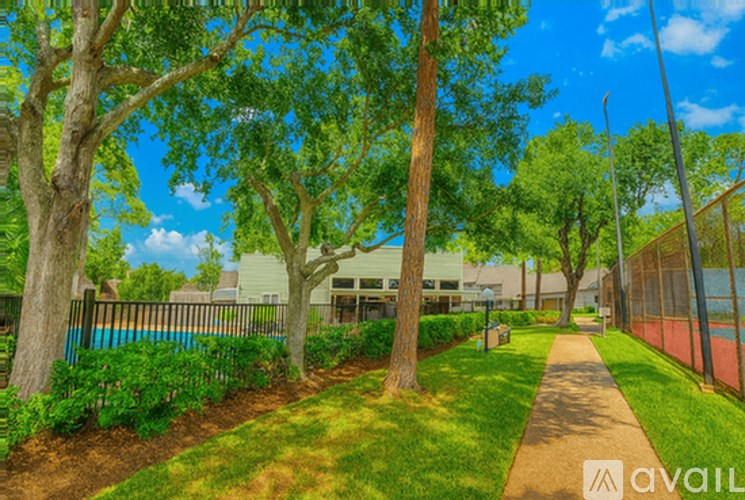 A tree-lined pathway in a park-like setting.
