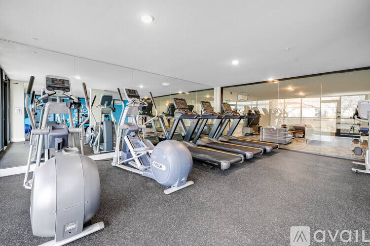 A gym with treadmills, exercise balls, and other equipment.