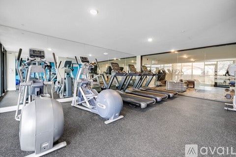 A gym with treadmills, exercise balls, and other equipment.