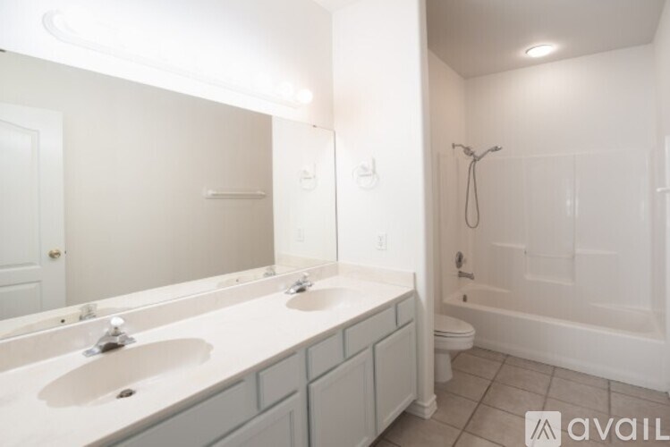 A bathroom with a white sink and a white toilet.