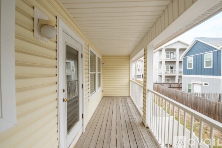 A balcony with a door and a window.
