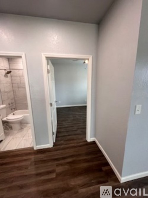A bathroom with a toilet and a shower stall.