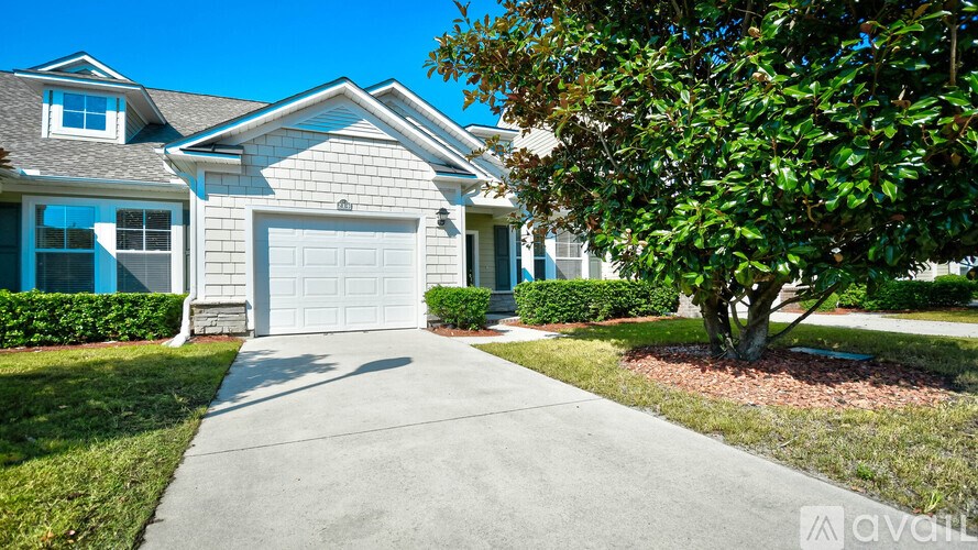 A house with a white garage door is for sale.