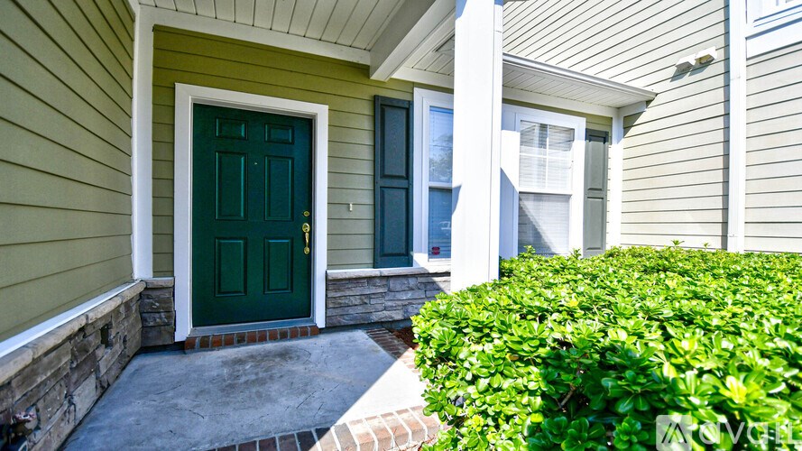 A green door is on the left side of the house.