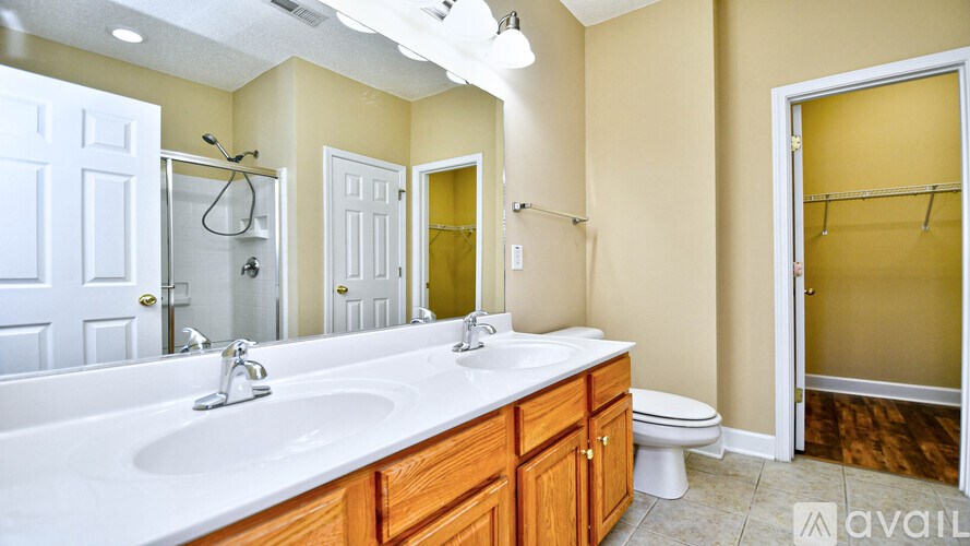 A bathroom with a white sink and a white toilet.