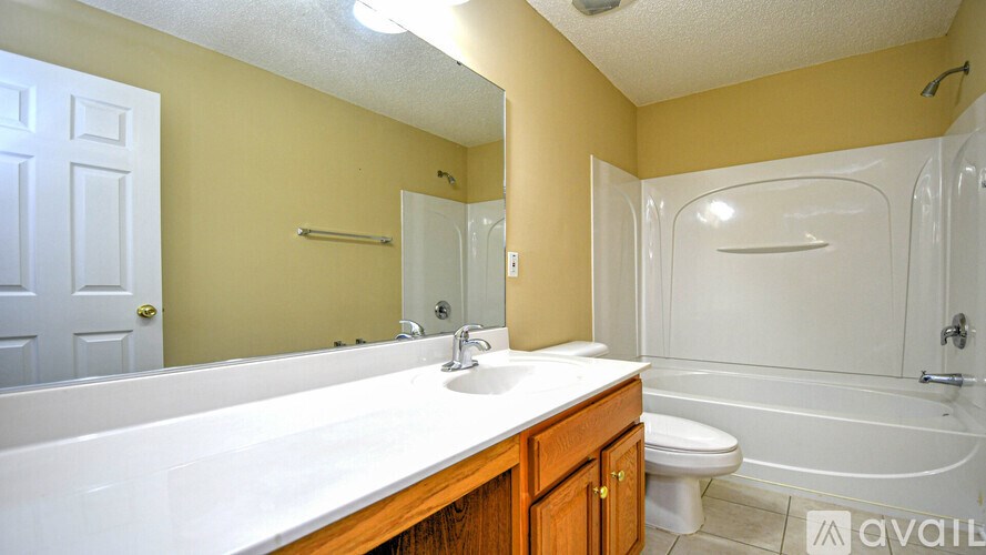 A bathroom with a white sink and a white bathtub.