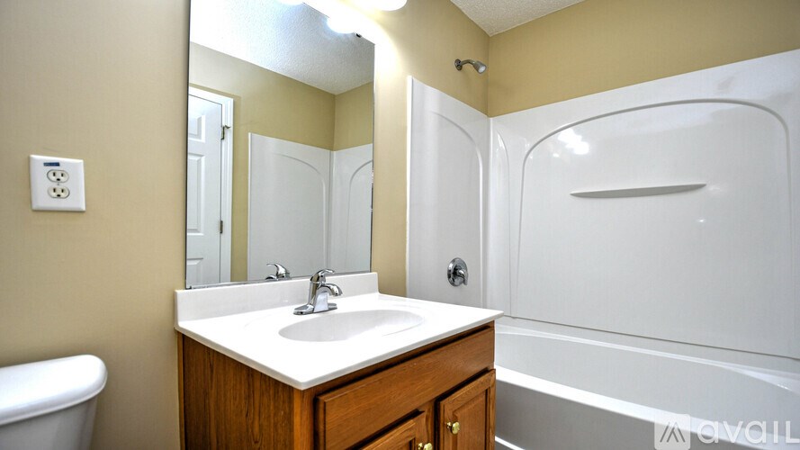 A bathroom with a white sink and a bathtub.
