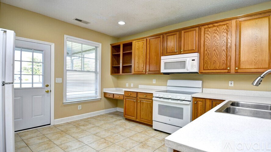 A kitchen with wooden cabinets and a white countertop.