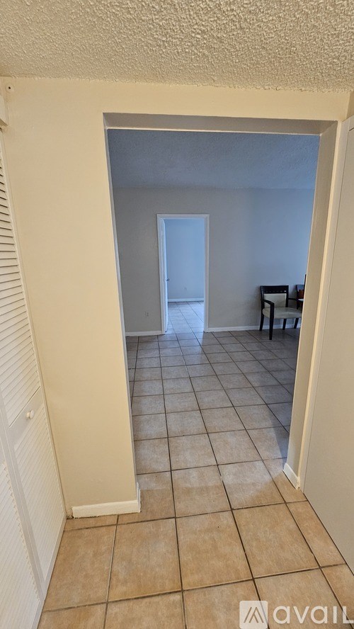 A room with a doorway leading to another room.