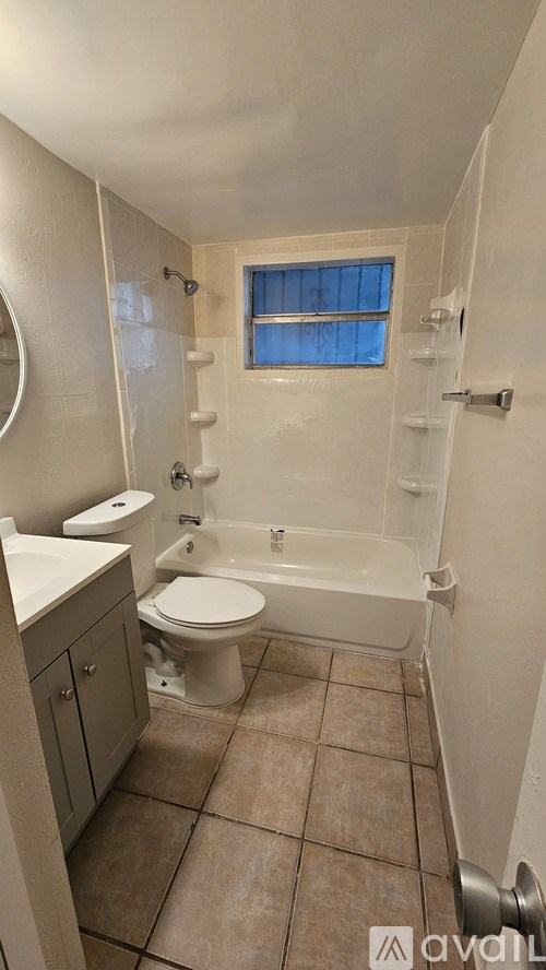 A small bathroom with a toilet, sink, and bathtub.